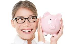 Woman smiling while holding piggy bank
