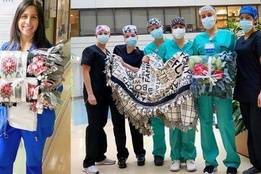 Woman and nurses holding various blankets outside hospital