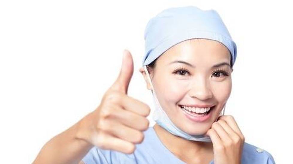 Healthcare worker wearing ppe and smiling