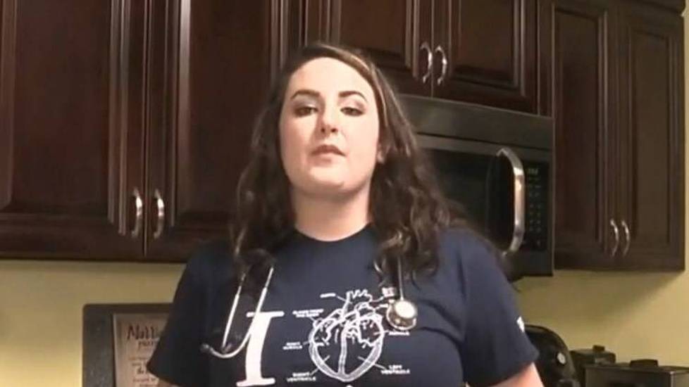 Nursing student at home with stethoscope and nursing shirt
