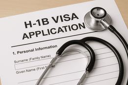 Stethoscope placed on an H-1B visa application form, symbolizing healthcare and immigration policy.
