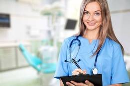 Young nurse taking notes in hospital room