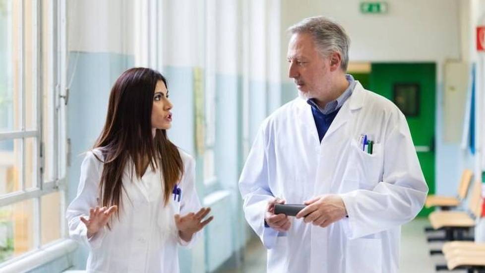 Two doctors in a heated discussion in hospital hallway
