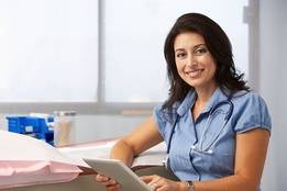 Happy nurse doctor reading over patient notes
