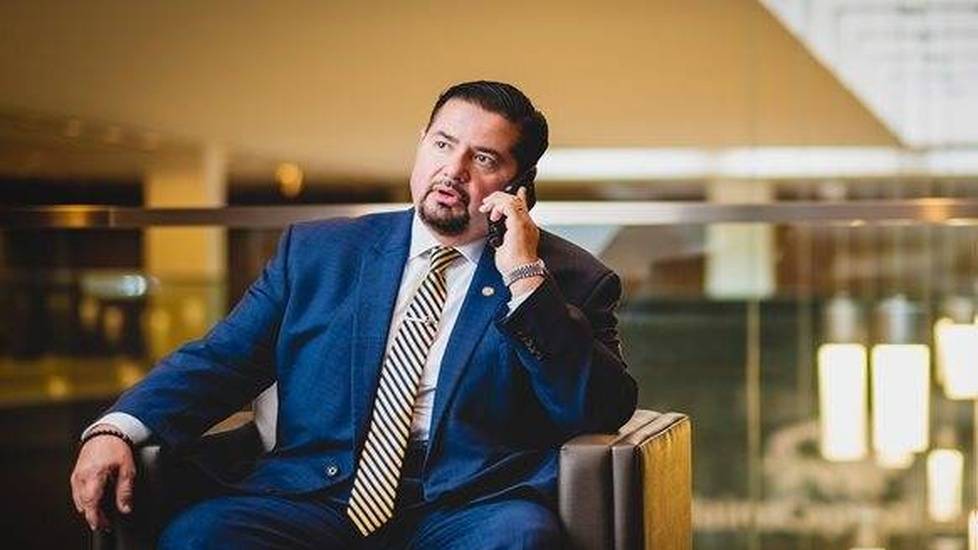 Lawyer talking on phone while sitting in chair in a lobby