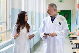 Two doctors in a heated discussion in hospital hallway