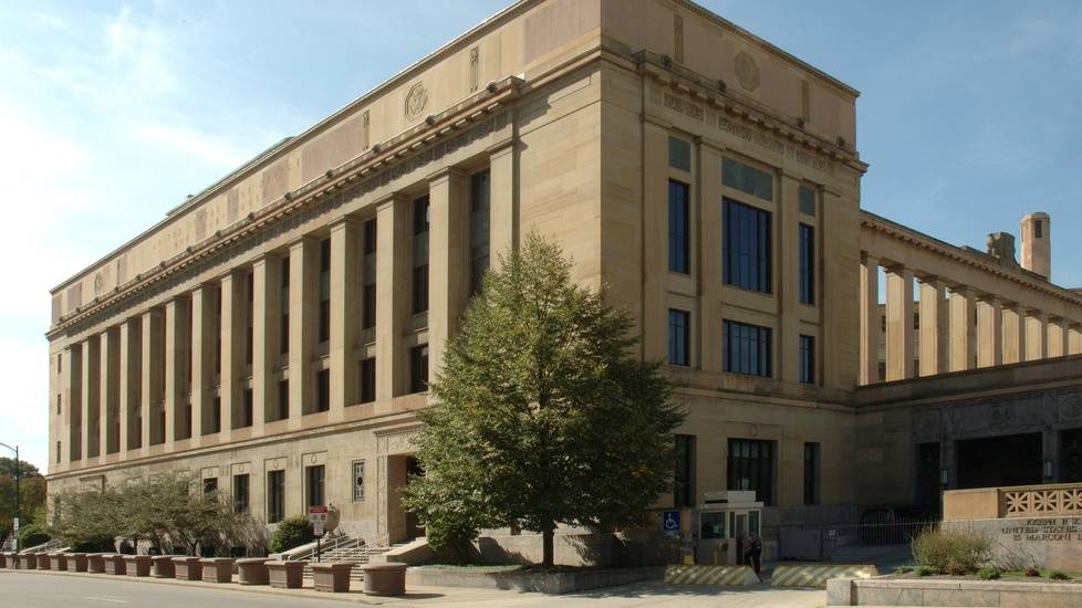 The U.S. District Court for the Southern District of Ohio, a beige stone courthouse with tall columns and a tree near the entrance.
