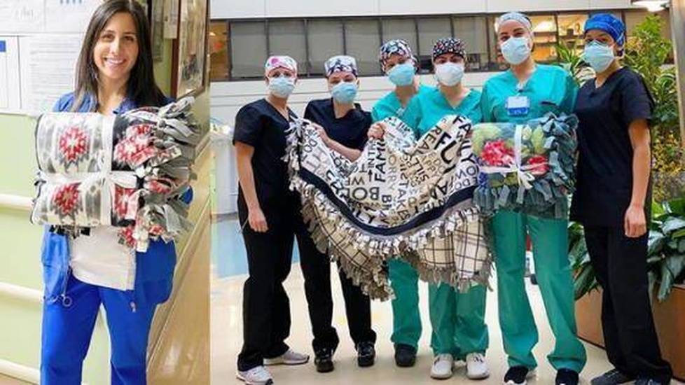 Woman and nurses holding various blankets outside hospital
