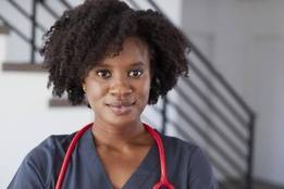 Nurse in gray scrubs with stethoscope
