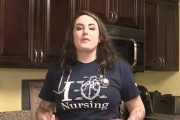 Nursing student at home with stethoscope and nursing shirt