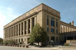The U.S. District Court for the Southern District of Ohio, a beige stone courthouse with tall columns and a tree near the entrance.