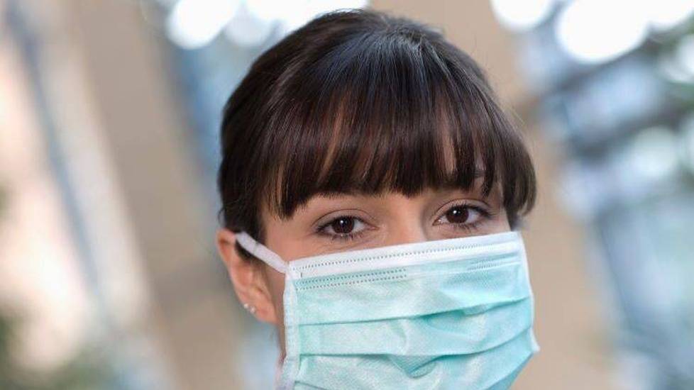 Young nurse wearing a face mask in a hospital