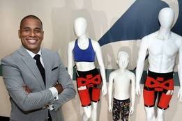 Man in suit posing with manikins wearing catheters