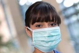 Young nurse wearing a face mask in a hospital